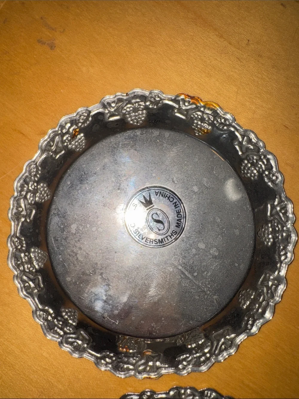 six vintage silver-plated drink coasters with ornate, embossed floral